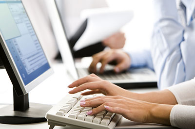 Person Typing on Keyboard